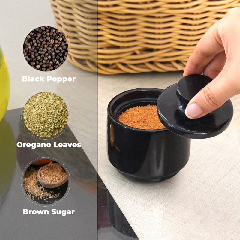 Black marble salt cellar used to store salt, pepper, and spices