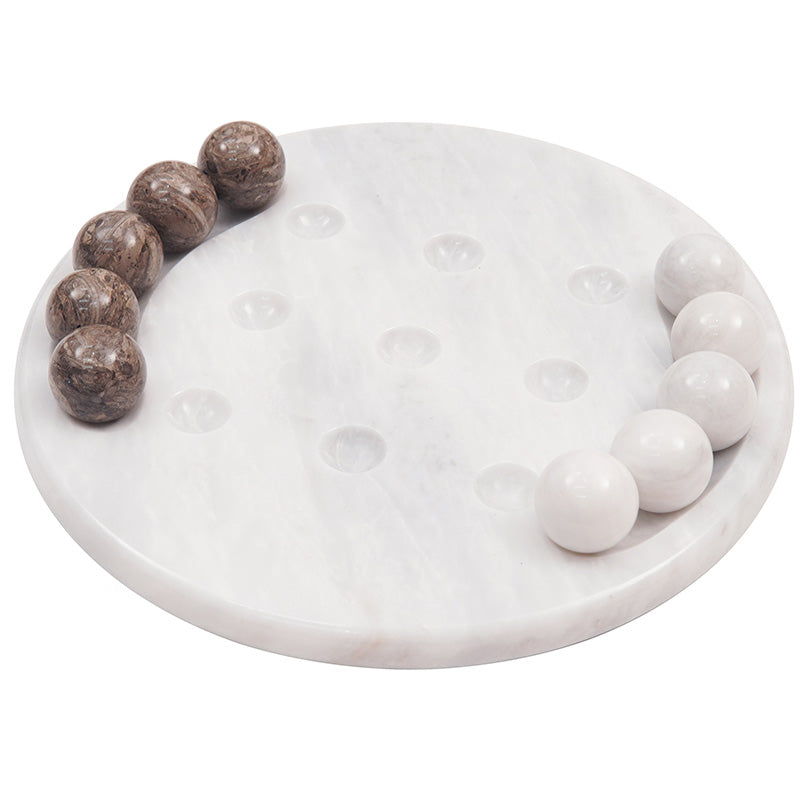 White marble tic tac toe board game with brown and white balls aligned in strategic positions