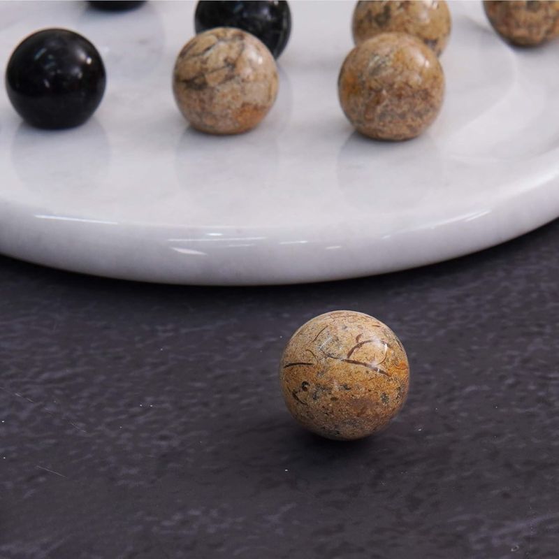 Close-up of coral marble ball from Tic Tac Toe game set