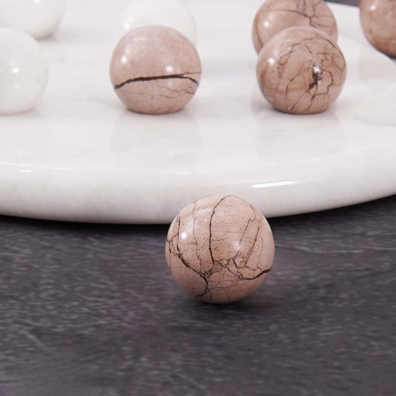 Close-up of marinara marble ball from Tic Tac Toe game set