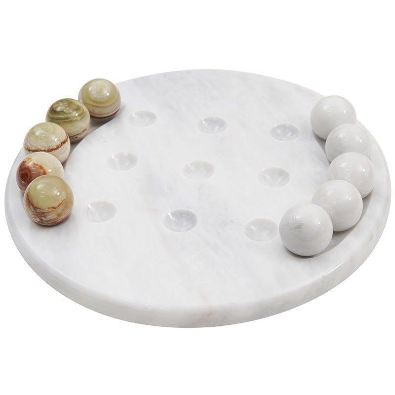 Close-up top angle of luxury marble tic tac toe game with white and green balls placed in row