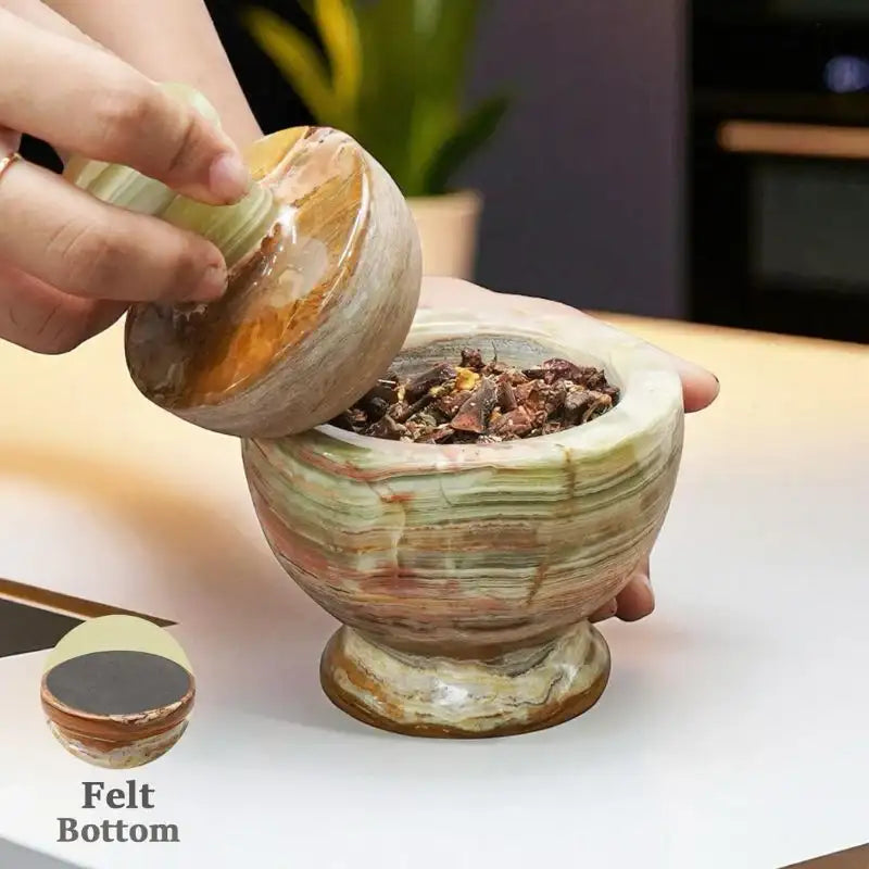 Front view of natural green marble mortar and pestle with smooth stone surface