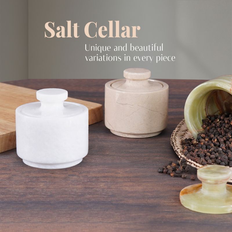 White and beige marble salt cellars on kitchen table for salt storage