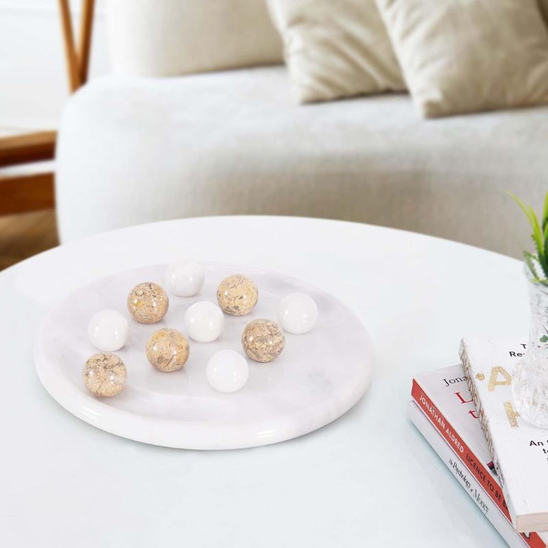 Coral and white marble Tic Tac Toe game set styled on coffee table