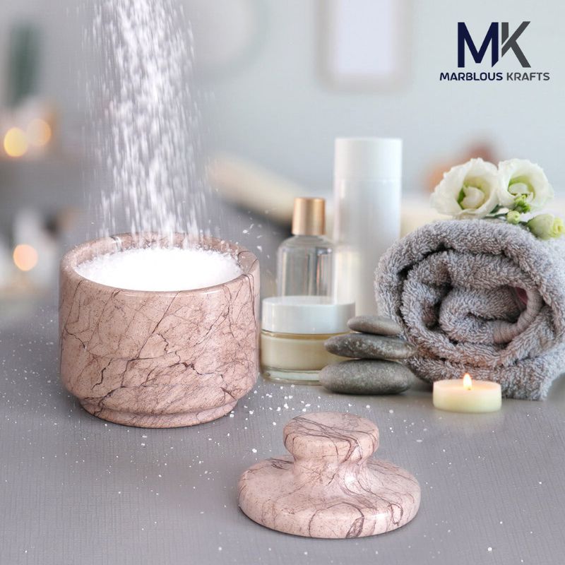 Marinara marble salt cellar placed in spa setting with salt and towels