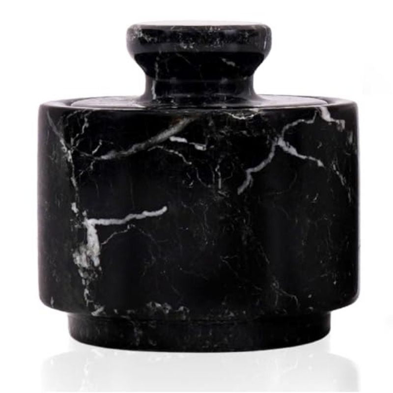 Black marble salt cellar filled with brown sugar, herbs, and spices